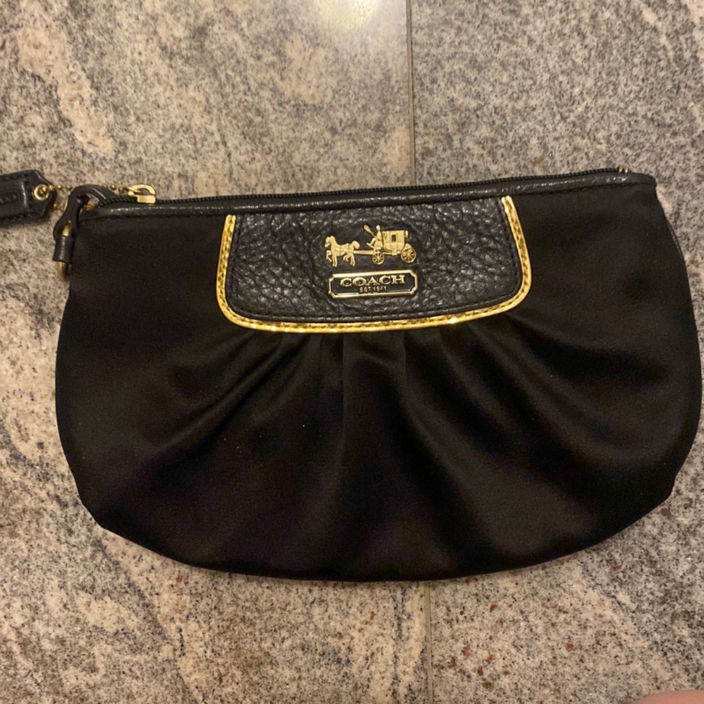 COACH black satin wristlet with gold accent logo.